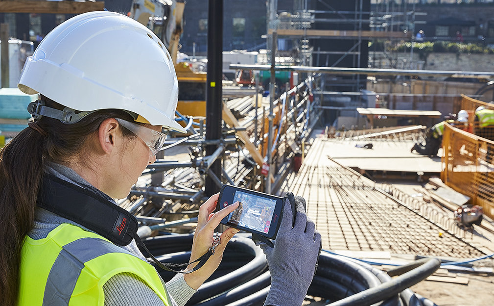 Woman using the Leica BLK3D at a construction site
