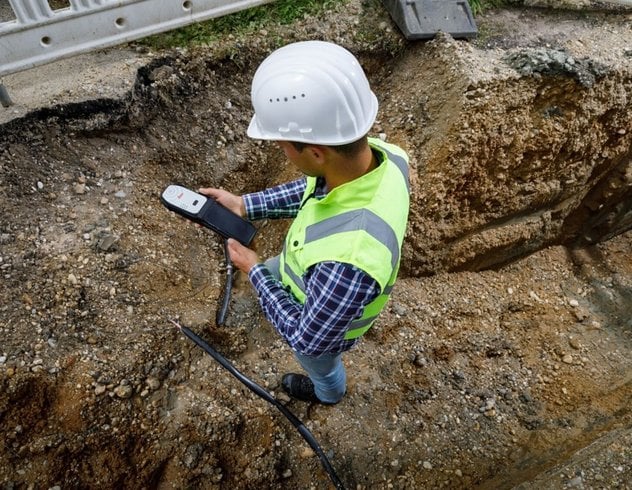Individual utilizing the Leica FLX100 at a site 